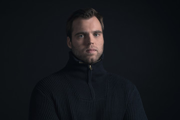Winter fashion man wearing dark blue turtleneck.