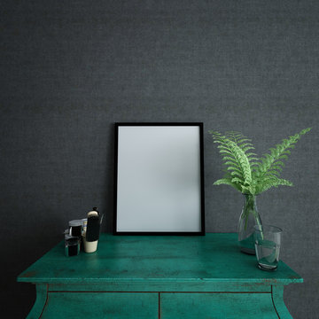 Blank picture frame on a green kist