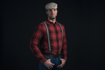 Hipster lumberjack fashion man wearing red checkered shirt and c