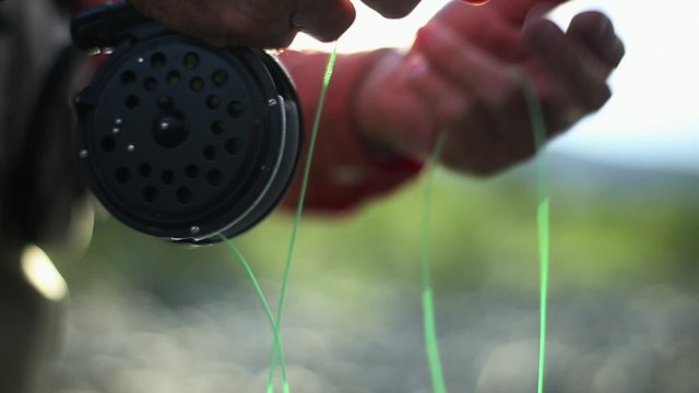 Older Fly Fisherman's Hands and Reel
