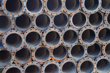 Stacked steel pipe bundle in industrial stockyard texture background