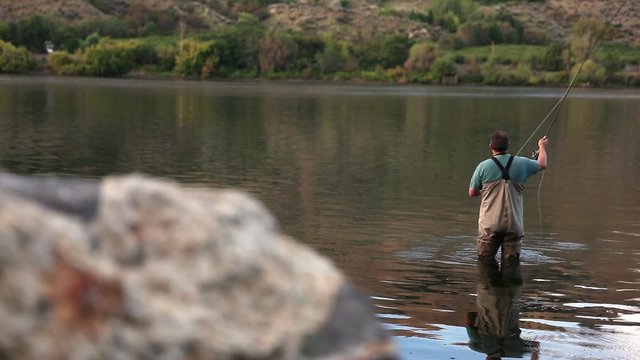 Slider shot of Fly Fisherman