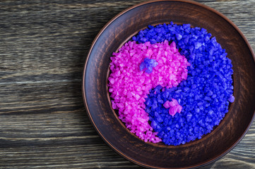 Lavender and rose salt in yin-yang sign on a wooden background