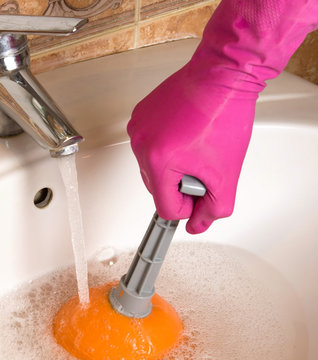 Hand cleaning sewers with cup plunger