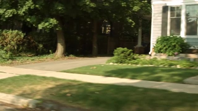 Driving plate: left three-quarters (passenger side) view, upper middle class 1930s and 40s-era homes in an affluent Mid West US neighborhood.  24mm lens, stabilized clip, moderate speed