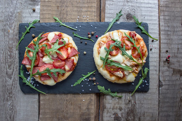 two mini pizzas and fresh arugula