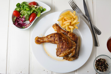 Roast chicken thighs and fries, and salad of lettuce and tomato