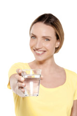 Portrait of a happy woman holding a glass of fresh water