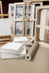 Empty white painter canvases and canvas roll and easel - painter
