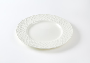 White porcelain plate with decorative rim
