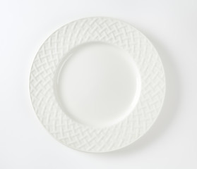 White porcelain plate with decorative rim