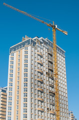Fototapeta na wymiar Construction crane and multi-storey building