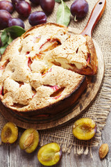 Pie with plums on the table