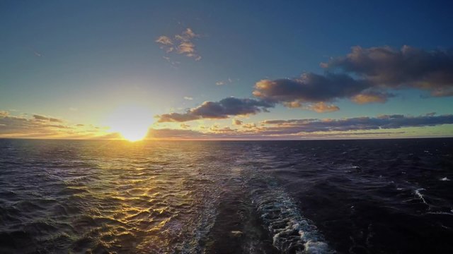 Travel by ferry in the Baltic Sea at sunrise. Time lapse