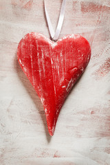 Wooden red heart on white, grunge background
