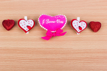 Five different hearts on a light wooden background