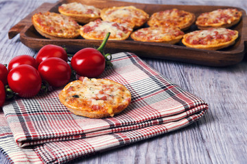 Mini pizzas on a wooden table
