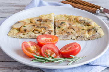 Delicious omelet with mushrooms and tomatoes
