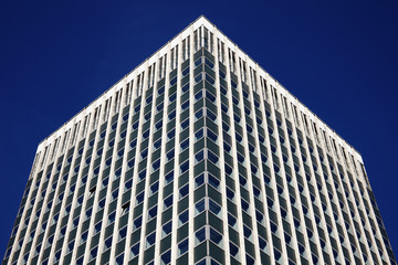 Modern futuristic tower block office skyscraper buildings architecture, with a clear blue sky in a downtown financial business district in England, UK