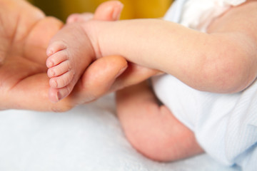 Obraz na płótnie Canvas Doctor massaging little baby's foot
