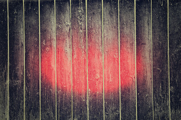 fantastic abstract background of black wooden planks with red mystical spot