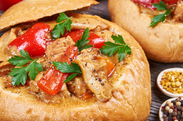 Stew made from meat, vegetables and mushrooms in a bread bowl