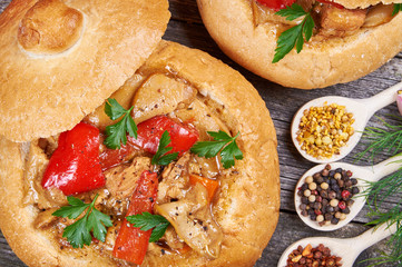 Stew made from meat, vegetables and mushrooms in a bread bowl