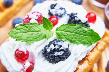 Homemade waffle with fruits and whipped cream