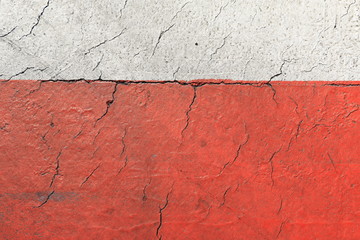 Red and white road marking on an asphalt road close-up
