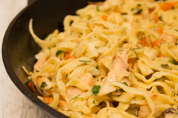 blurred background homemade noodles with chicken meat in a fryin