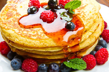 Pancakes with berries and maple syrup