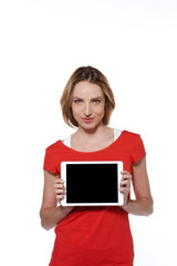 Naklejka premium Young modern woman presenting a tablet - isolated on white