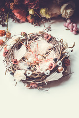 White pillow for wedding rings in a bird nest style.