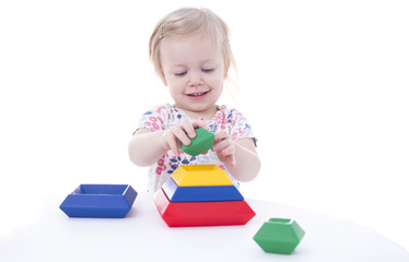 toddler girl stacking blocks