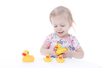 toddler girl playing with ducks