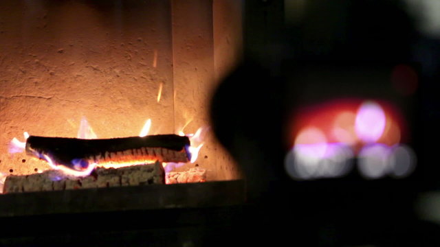 A process of indoor footage shooting with DSLR camera: working fireplace