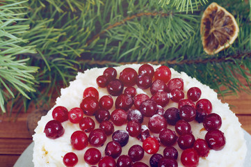 Holiday layered cake with cream and cranberry decoration