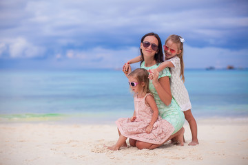 Young mother and her little daughters enjoy summer vacation