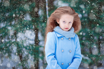 Adorable little girl in winter outdoors on Xmas eve