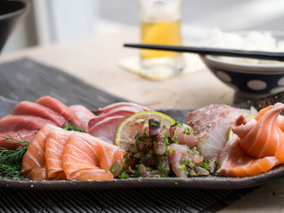 Japanese sashimi on a black dish