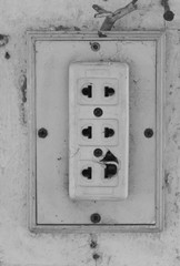 old vintage electric plug socket with wall background.