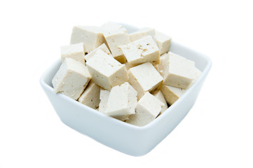 Cubes of tofu square bowl on a white background