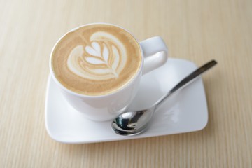 hot milk art coffee on wooden table