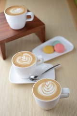 Cappuccino coffee and pastries on old wooden table