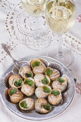 White wine in wine glasses and snails
