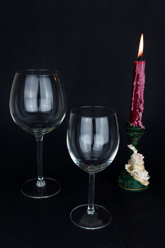 wine glass and candle on black background