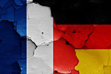 flags of France and Germany painted on cracked wall