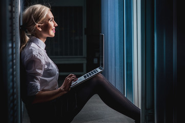 Young engineer businesswoman in server room