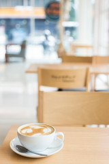 Hot art Latte Coffee in a cup on wooden table