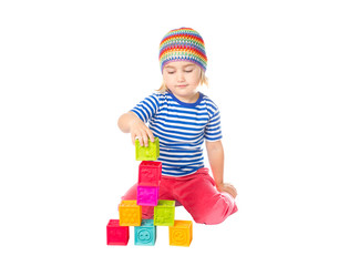 Little girl playing cubes sitting .